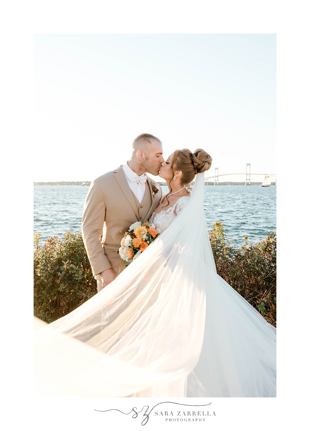 newlyweds kiss with bride's veil around them in Newport RI