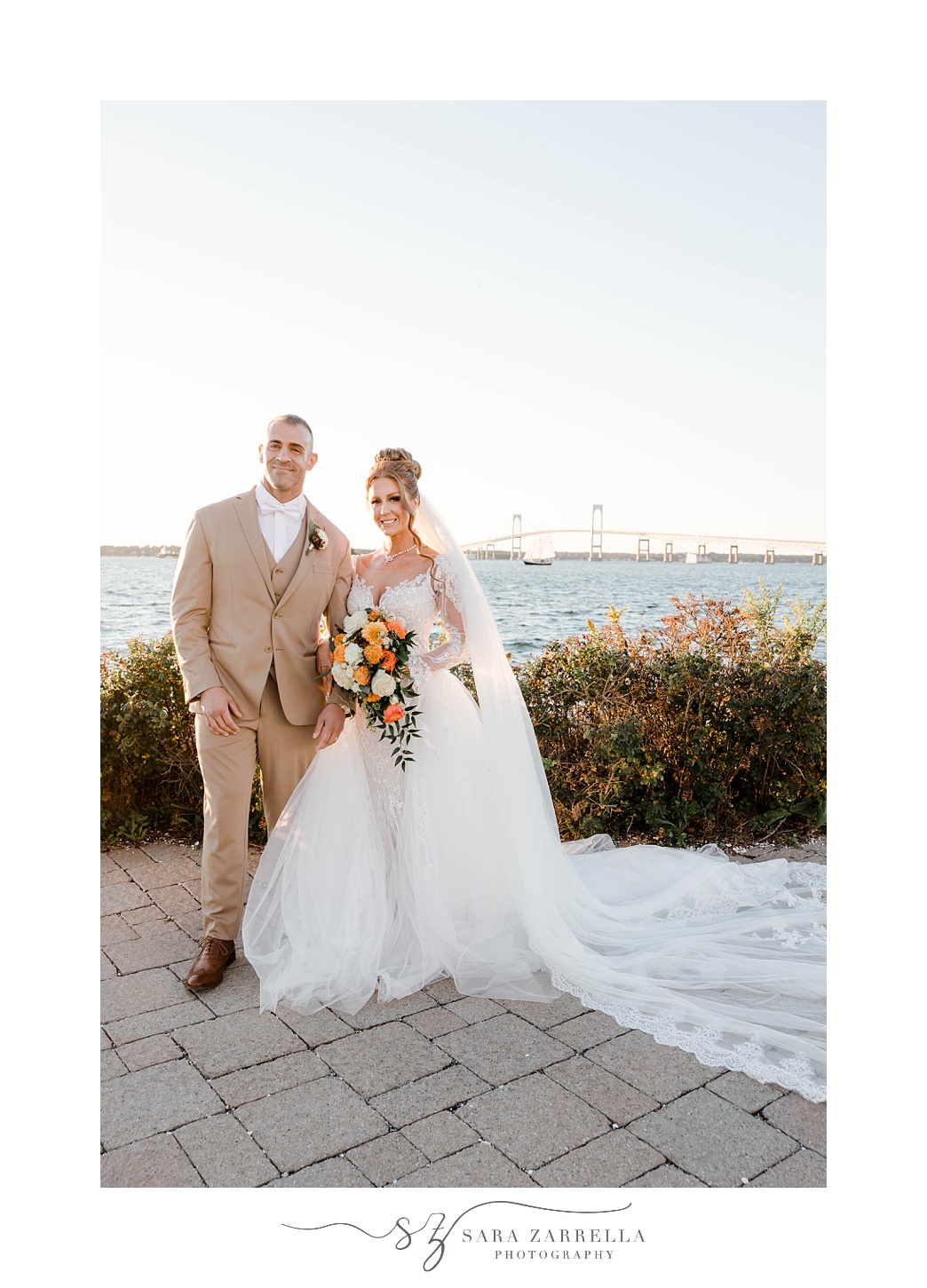 bride and groom hug on patio at Newport Harbor Island Resort