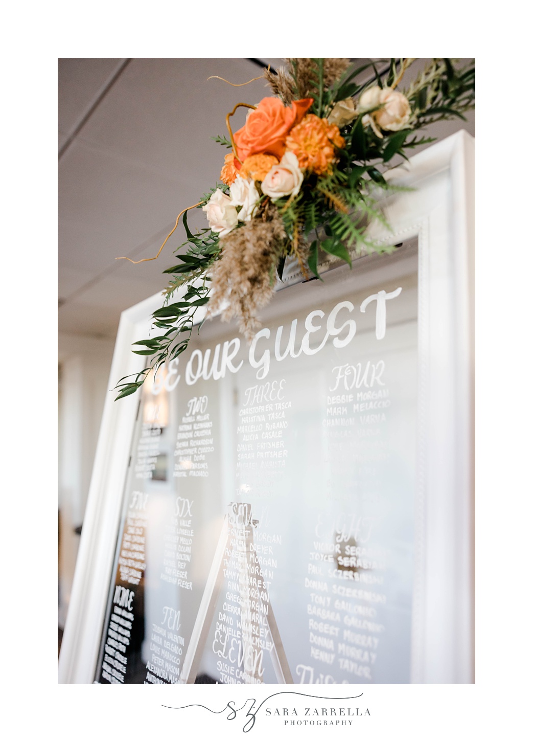 guest list sign on mirror with orange florals at Newport Harbor Island Resort 