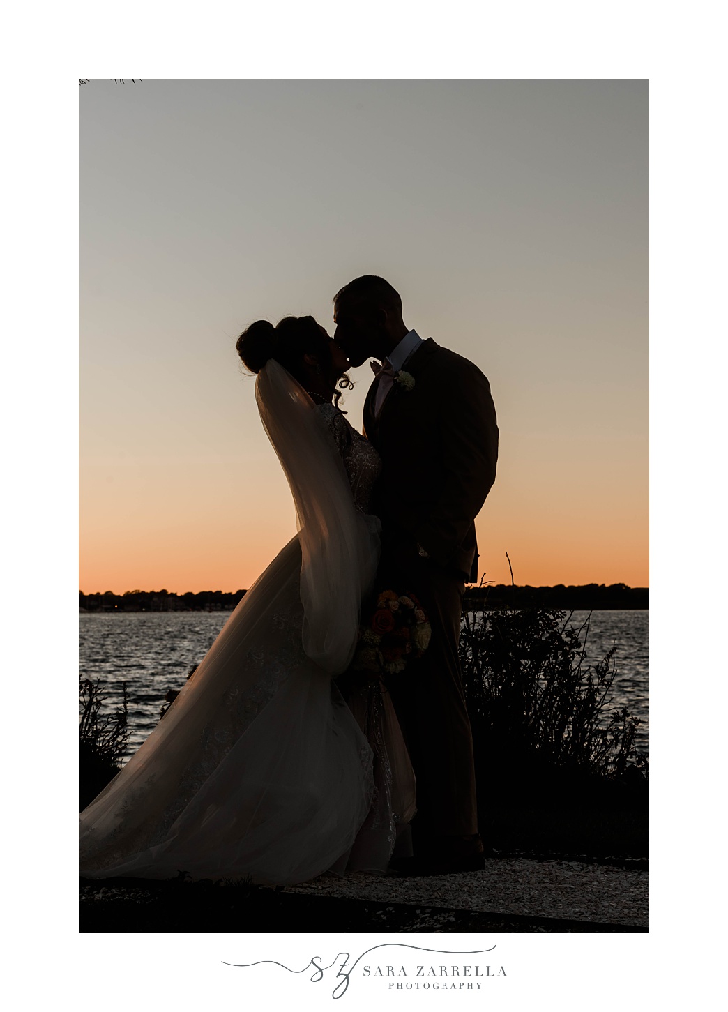 sunset wedding portraits of bride and groom kissing in Newport RI