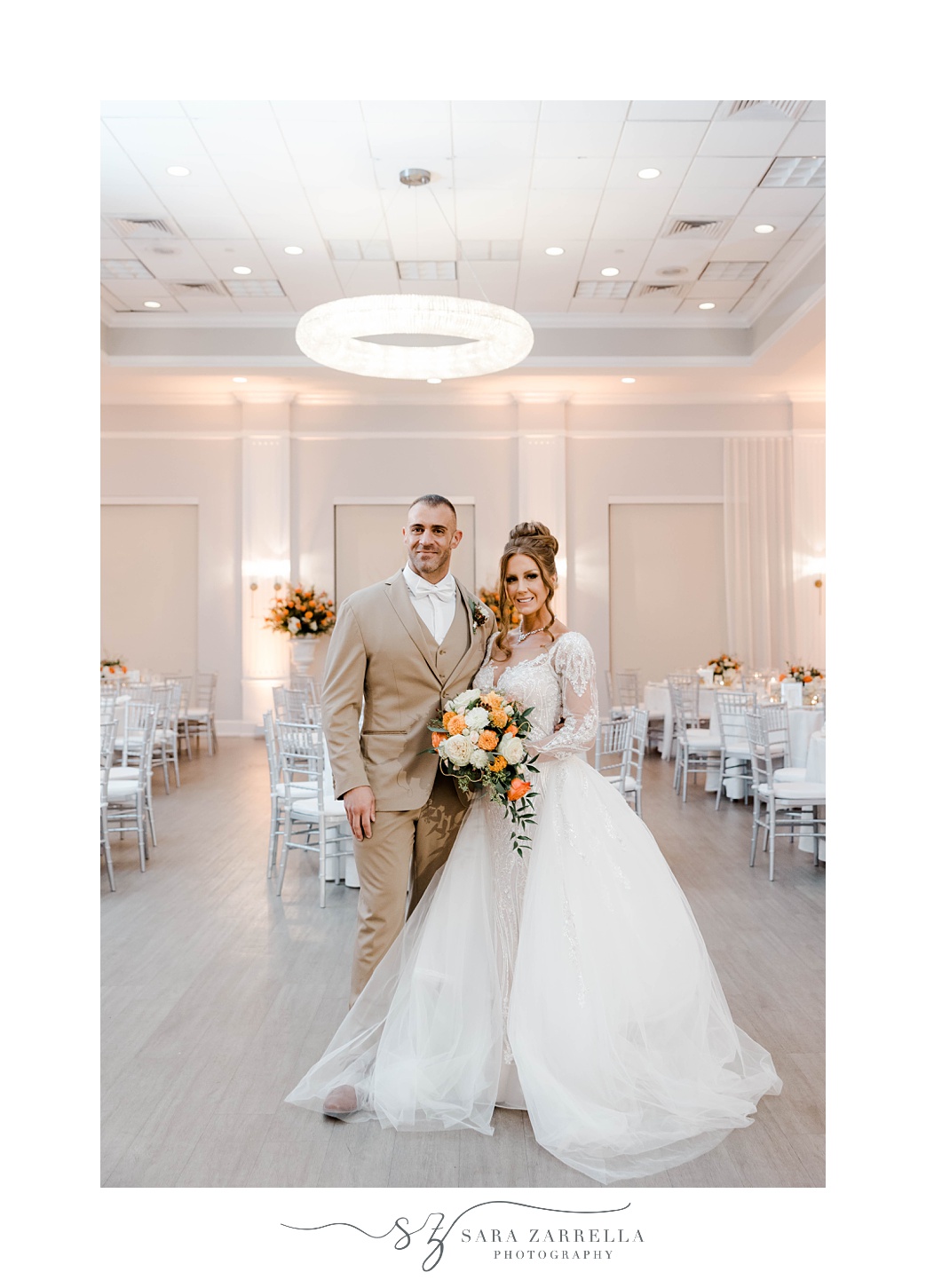 bride and groom stand in empty ballroom before reception at Newport Harbor Island Resort