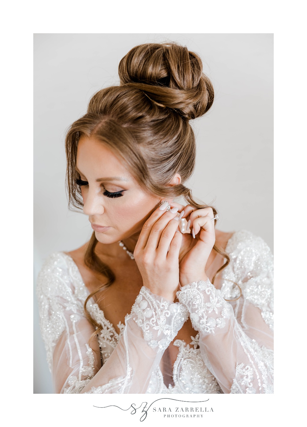 bride adjusts earrings before Newport RI wedding 