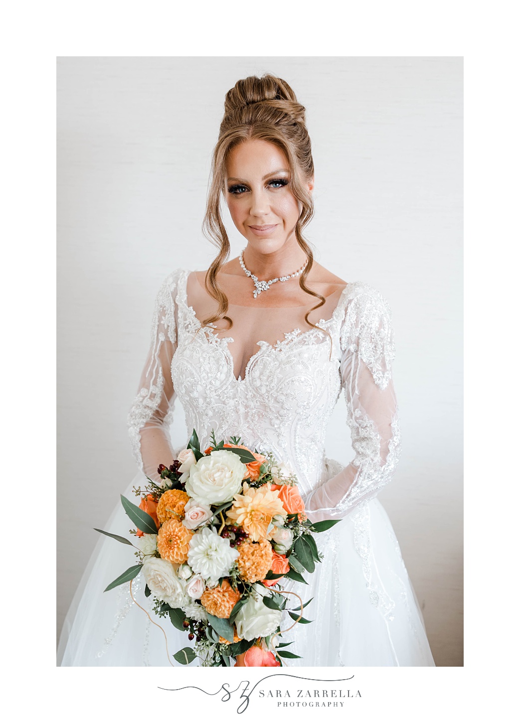 bride poses in wedding gown with lace wedding sleeves