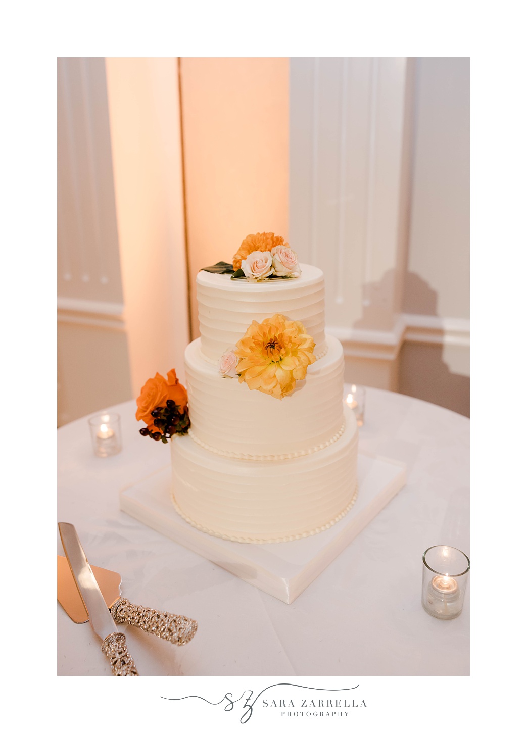 fall wedding cake with tiered layers and yellow and orange flowers 
