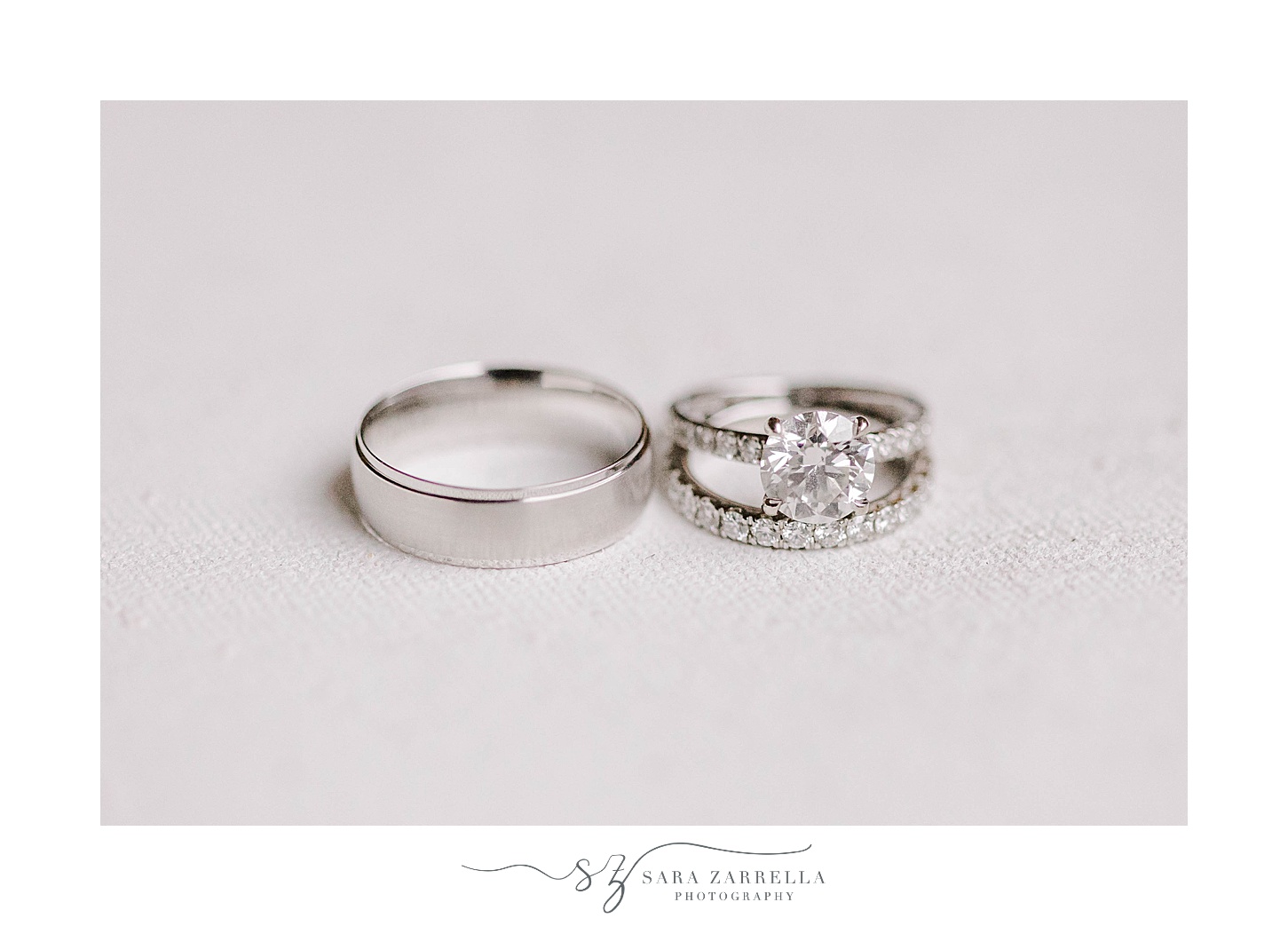 wedding bands rest stacked on ivory backdrop