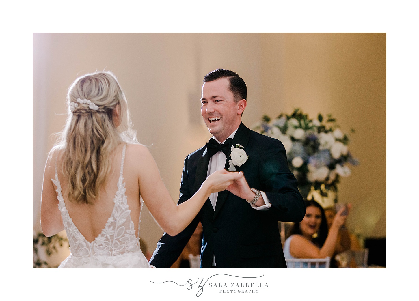 groom laughs with bride during first dance 