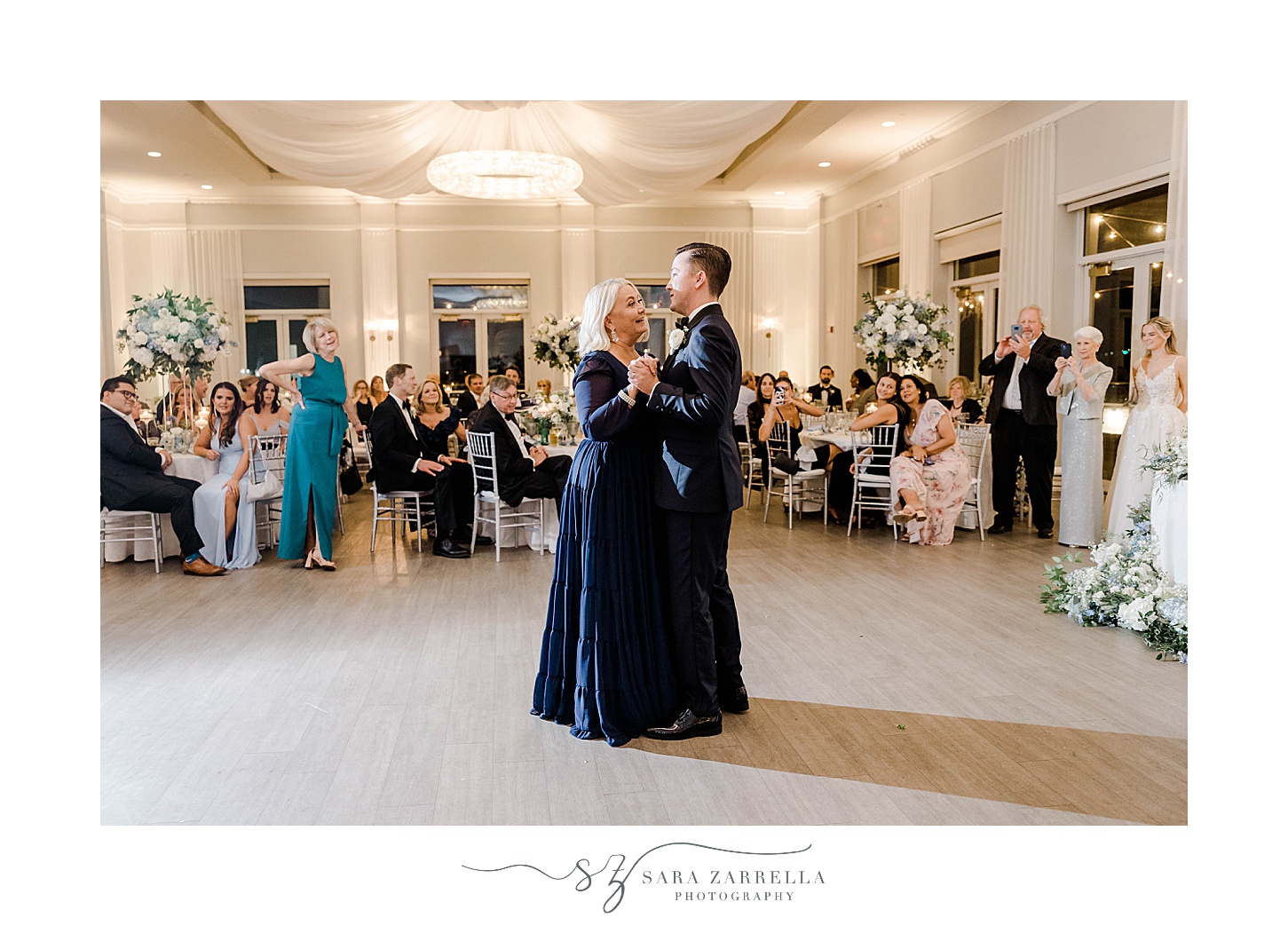 groom dances with mom in navy gown during Newport wedding reception