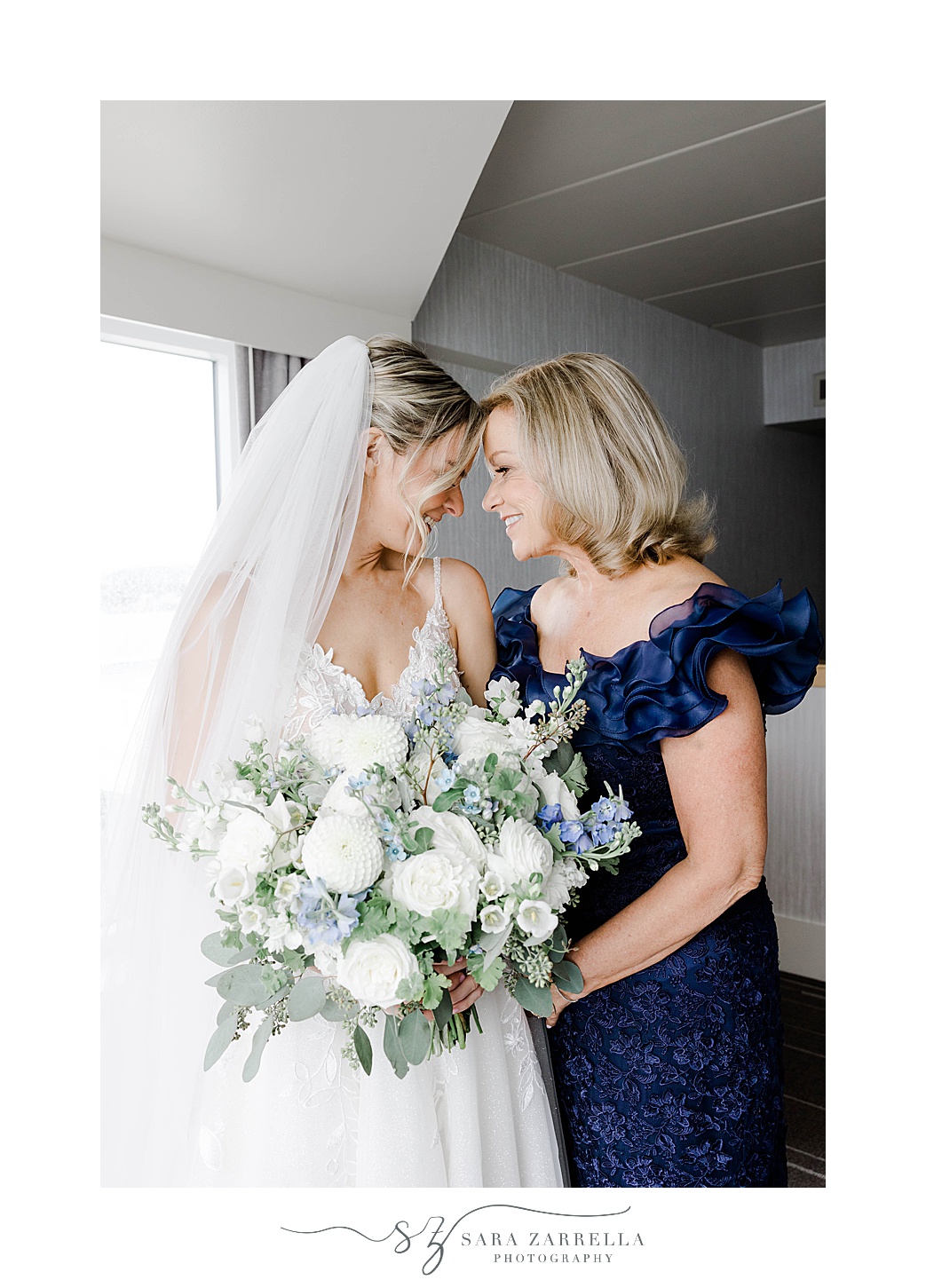 bride and mother lean heads together smiling at Newport Harbor Island Resort