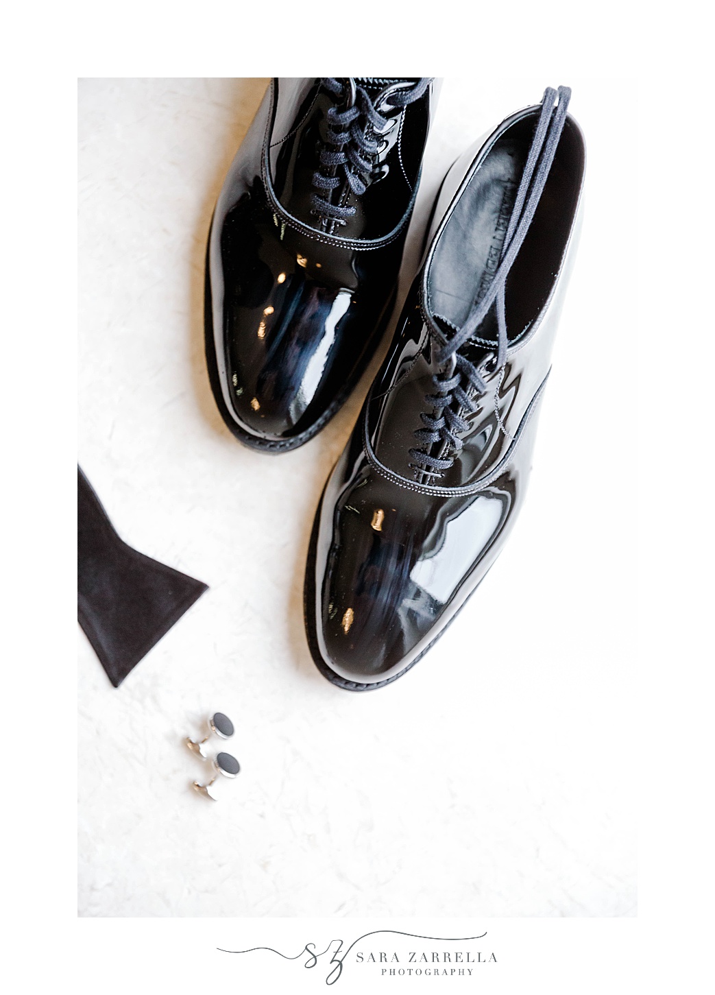 groom's classic black shoes and cufflinks