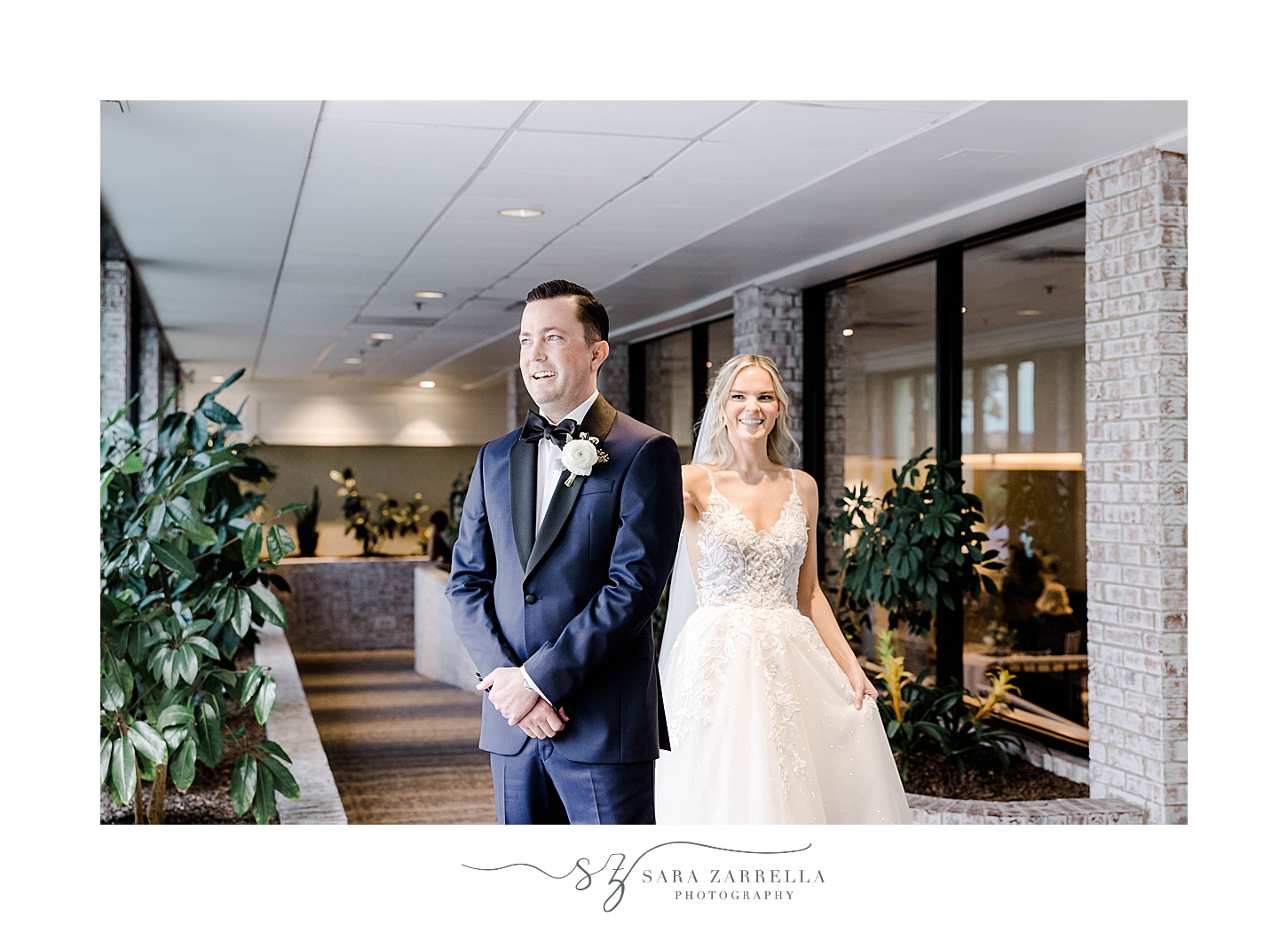 bride approaches groom for first look in lobby at Newport Harbor Island Resort