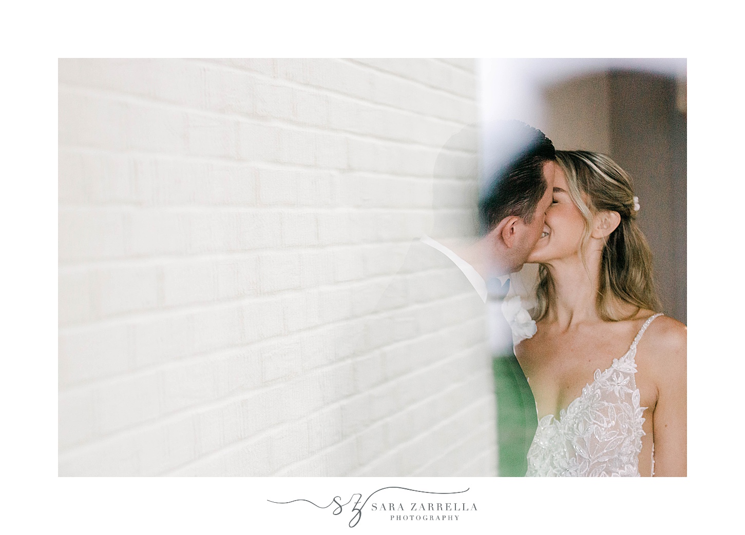 bride and groom kiss with double exposure of brick wall 