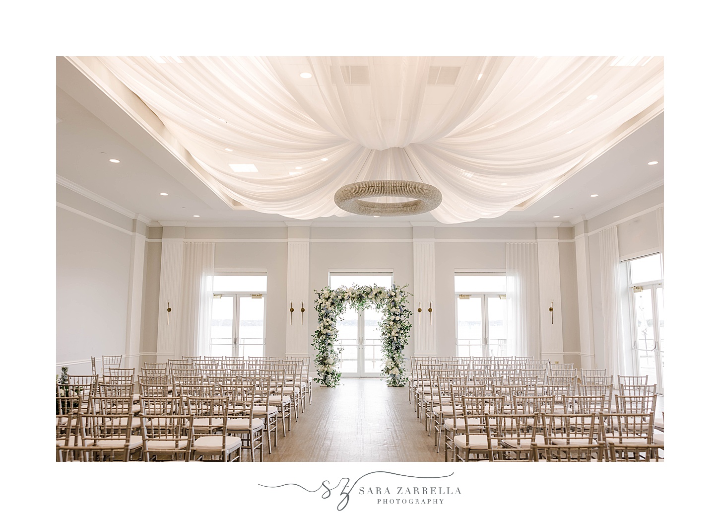 wedding ceremony inside Newport Harbor Island Resort with white florals