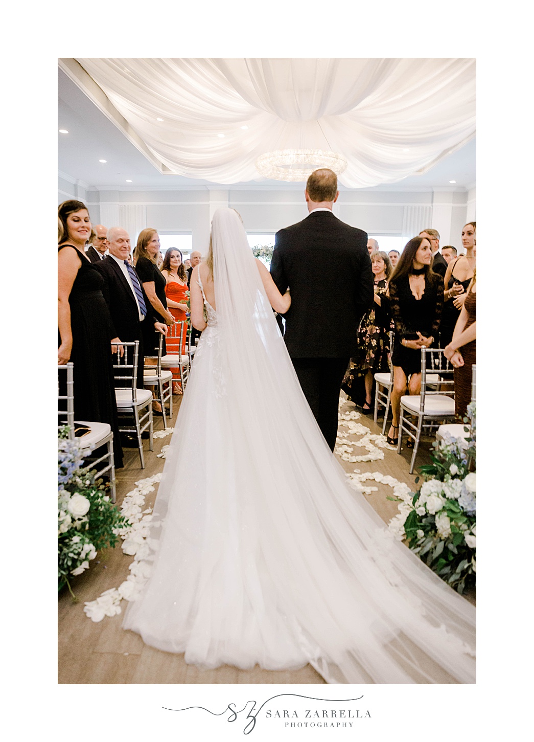 bride walks down aisle with father at Newport Harbor Island Resort