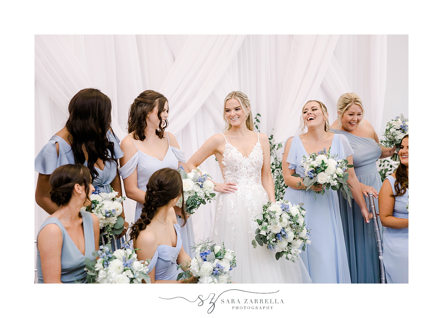 bride and bridesmaids laugh together inside Newport Harbor Island Resort