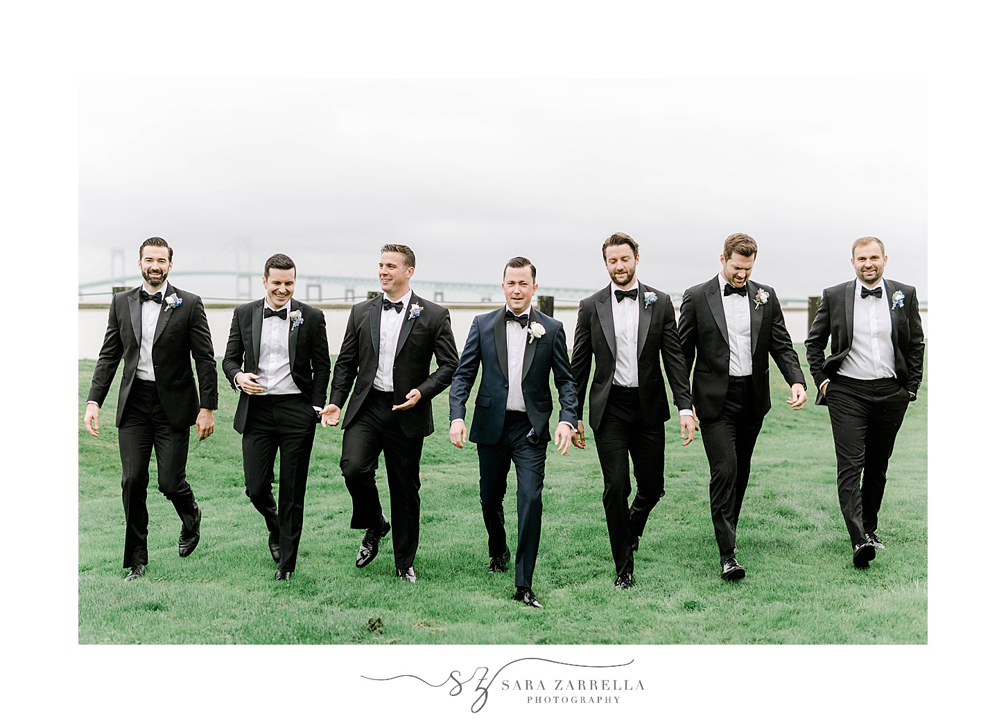 groom and groomsmen walk in Newport RI