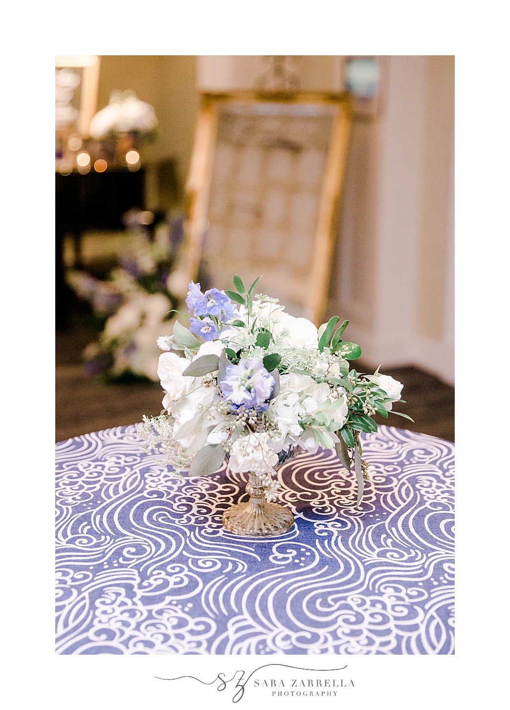 blue and white floral centerpieces with hydrangeas on blue tablecloth 