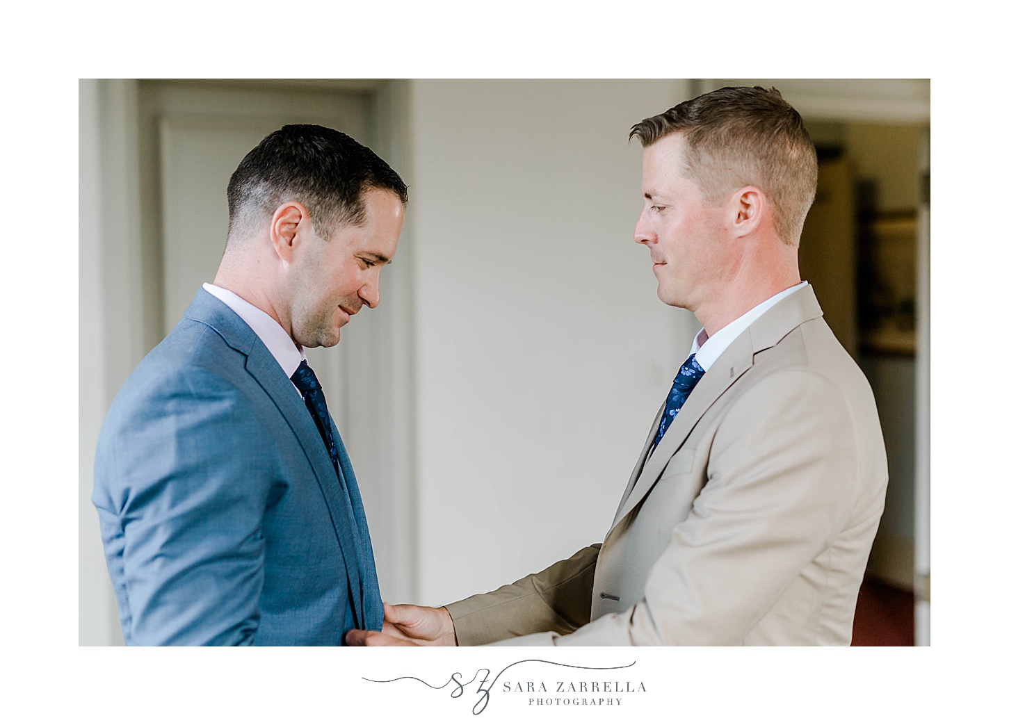 groom helps partner with jacket before RI wedding