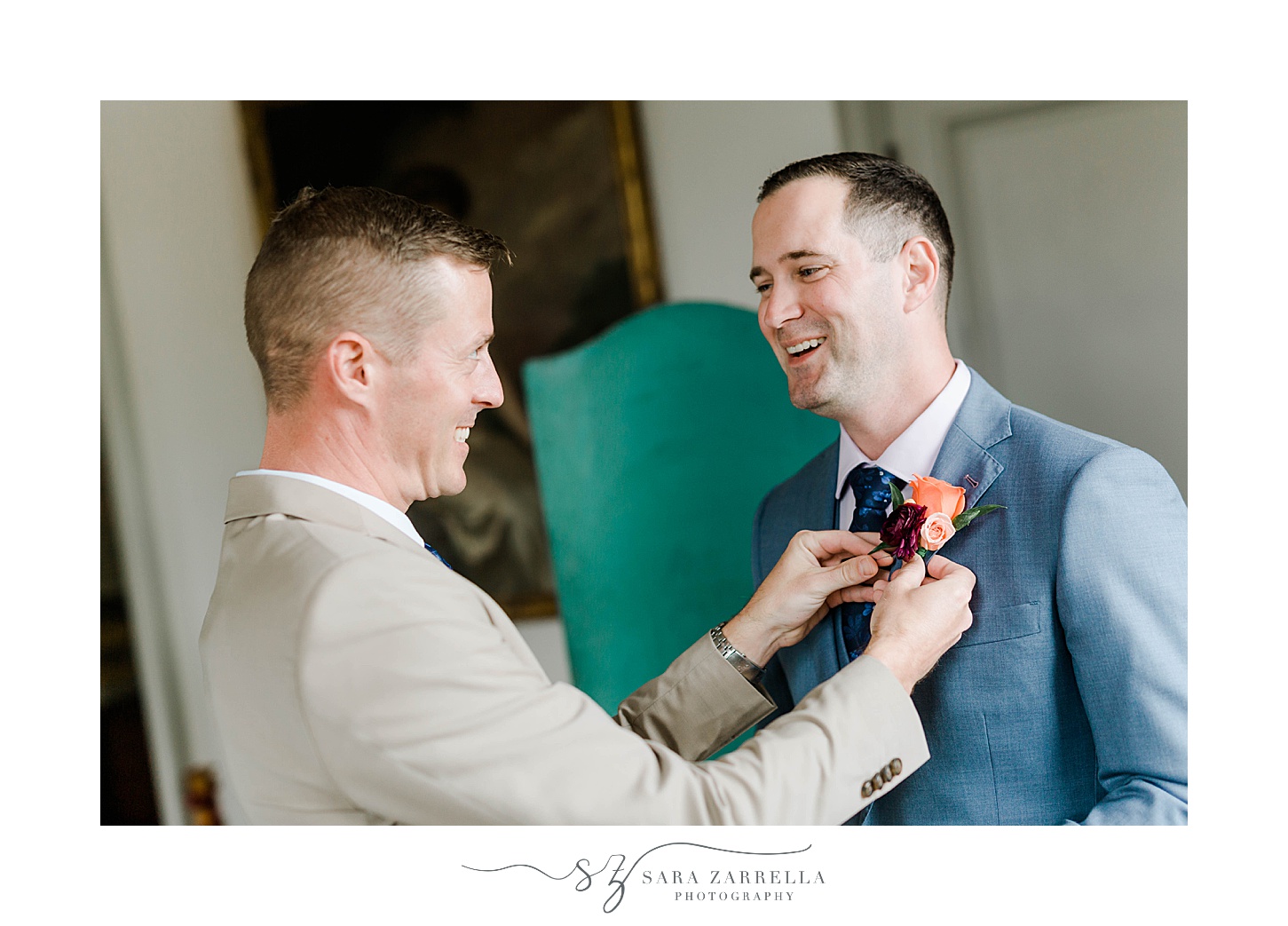 groom adjusts boutineere for groom before RI wedding