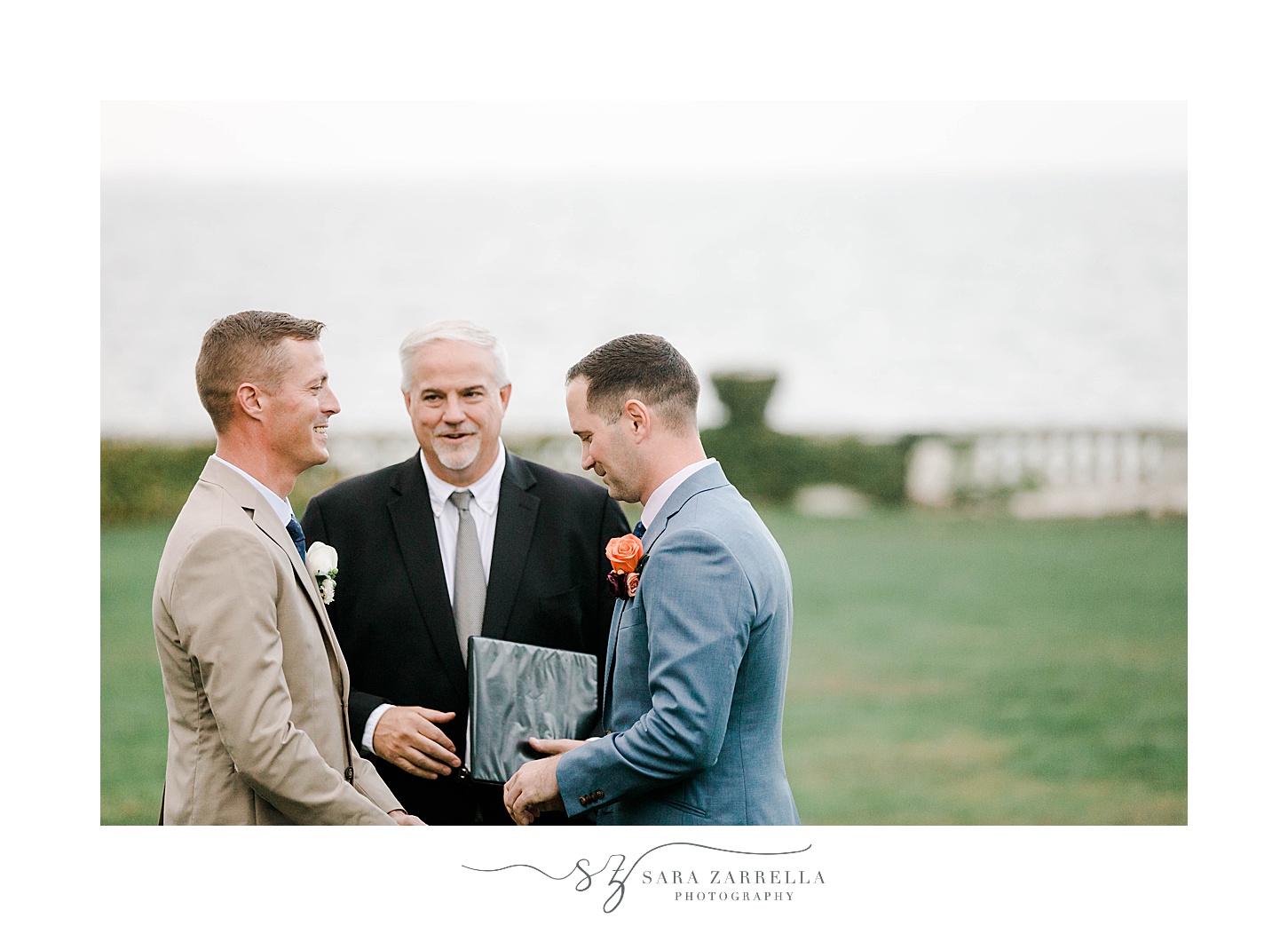 grooms exchange vows during ceremony at Rosecliff Mansion