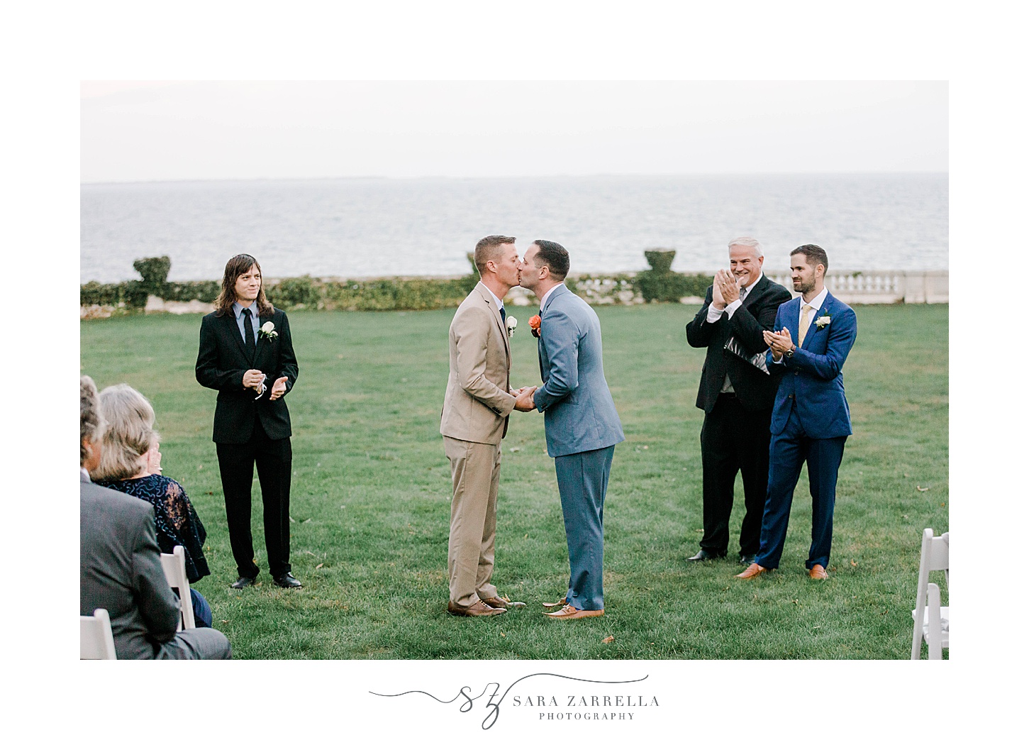husbands kiss during ceremony at Rosecliff Mansion