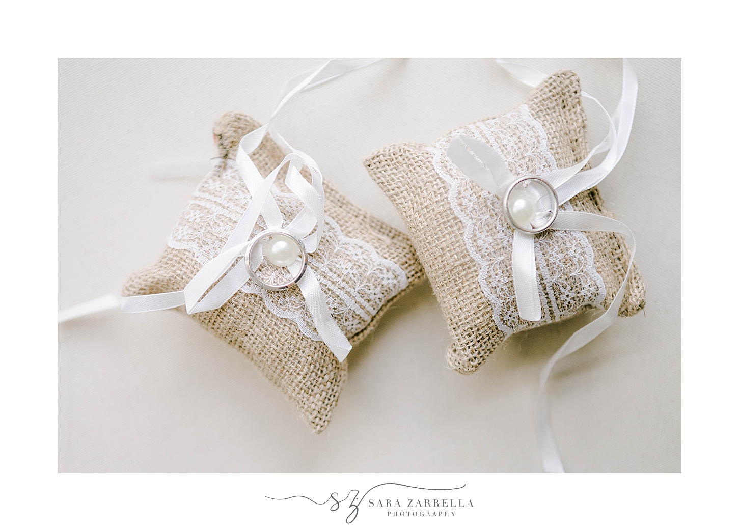 rings rest on burlap pillow with lace