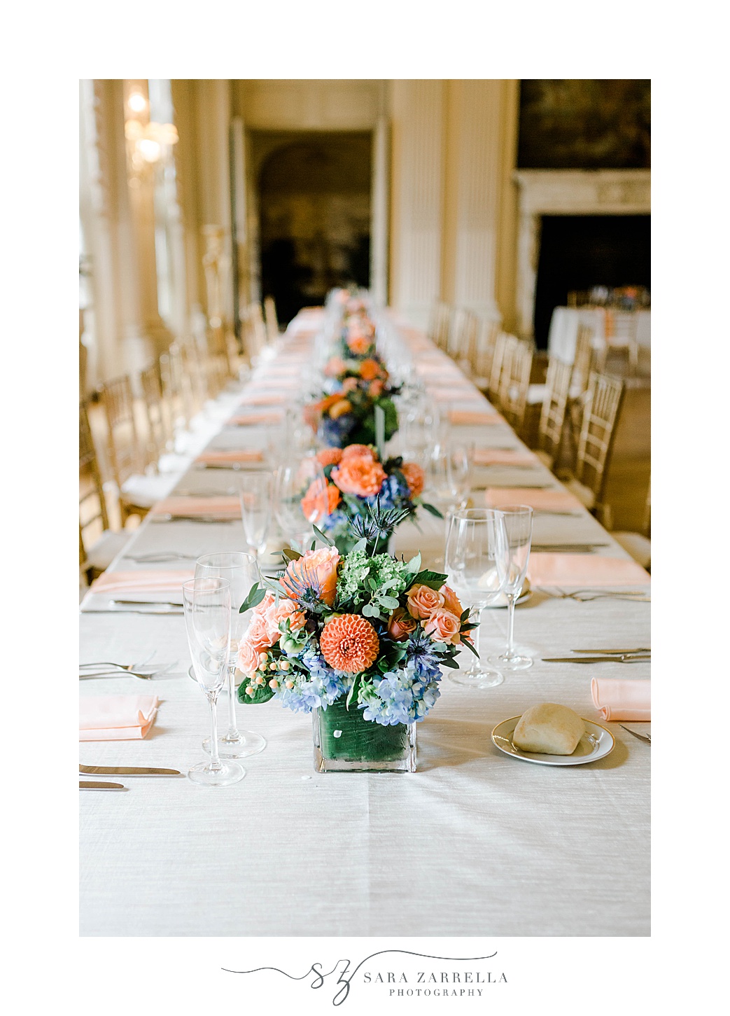 peach and blue floral centerpieces for family style tables at Rosecliff Mansion