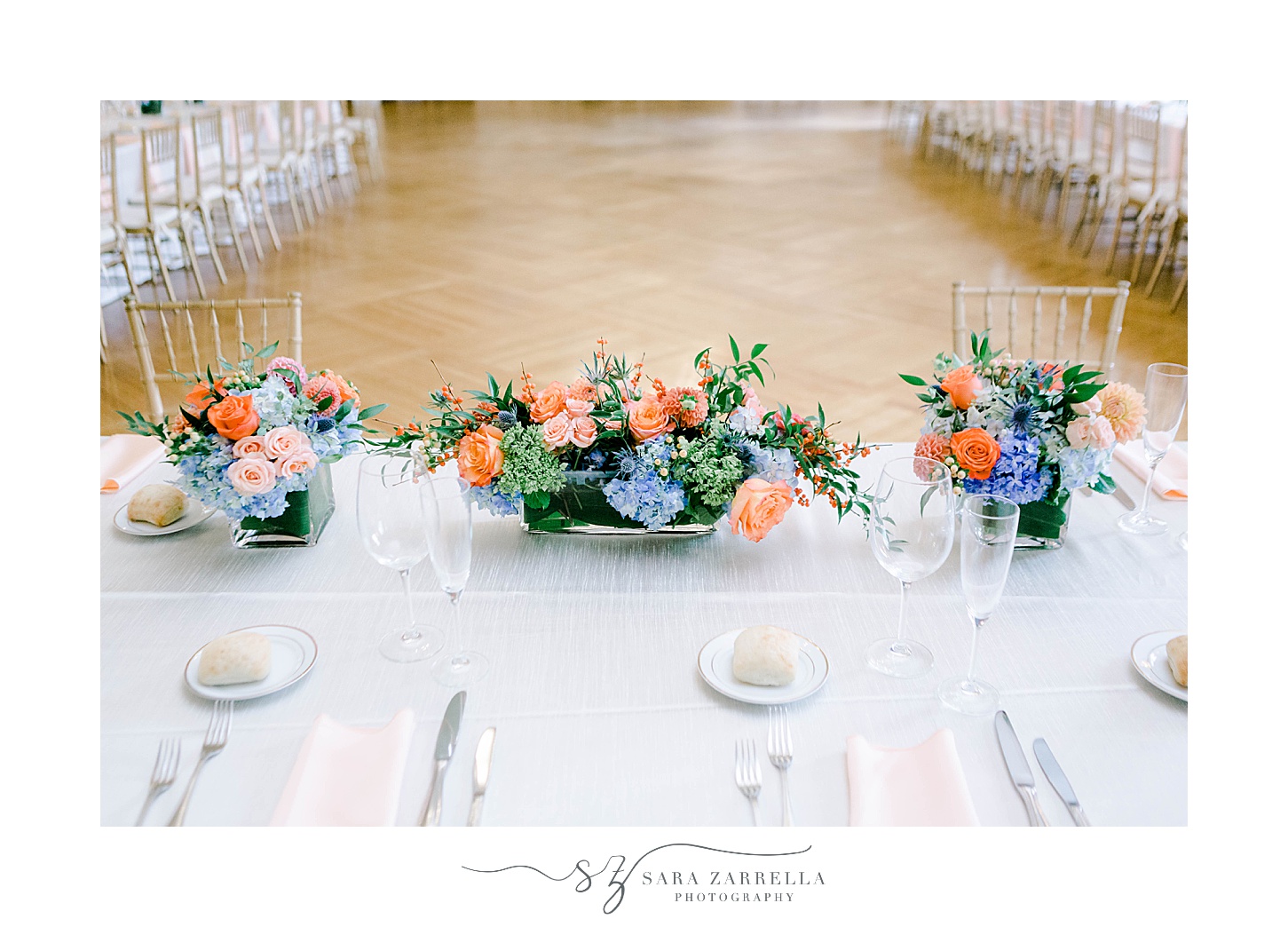 pink and blue wedding reception florals on table at Rosecliff Mansion 