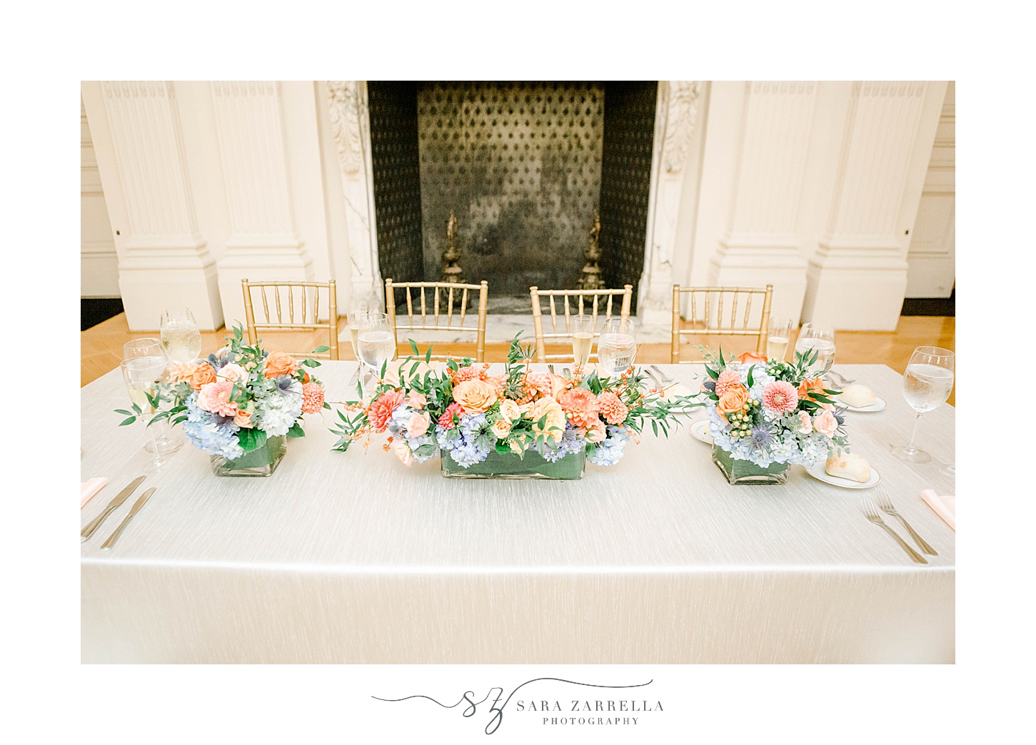 head table with pink and blue floral displays