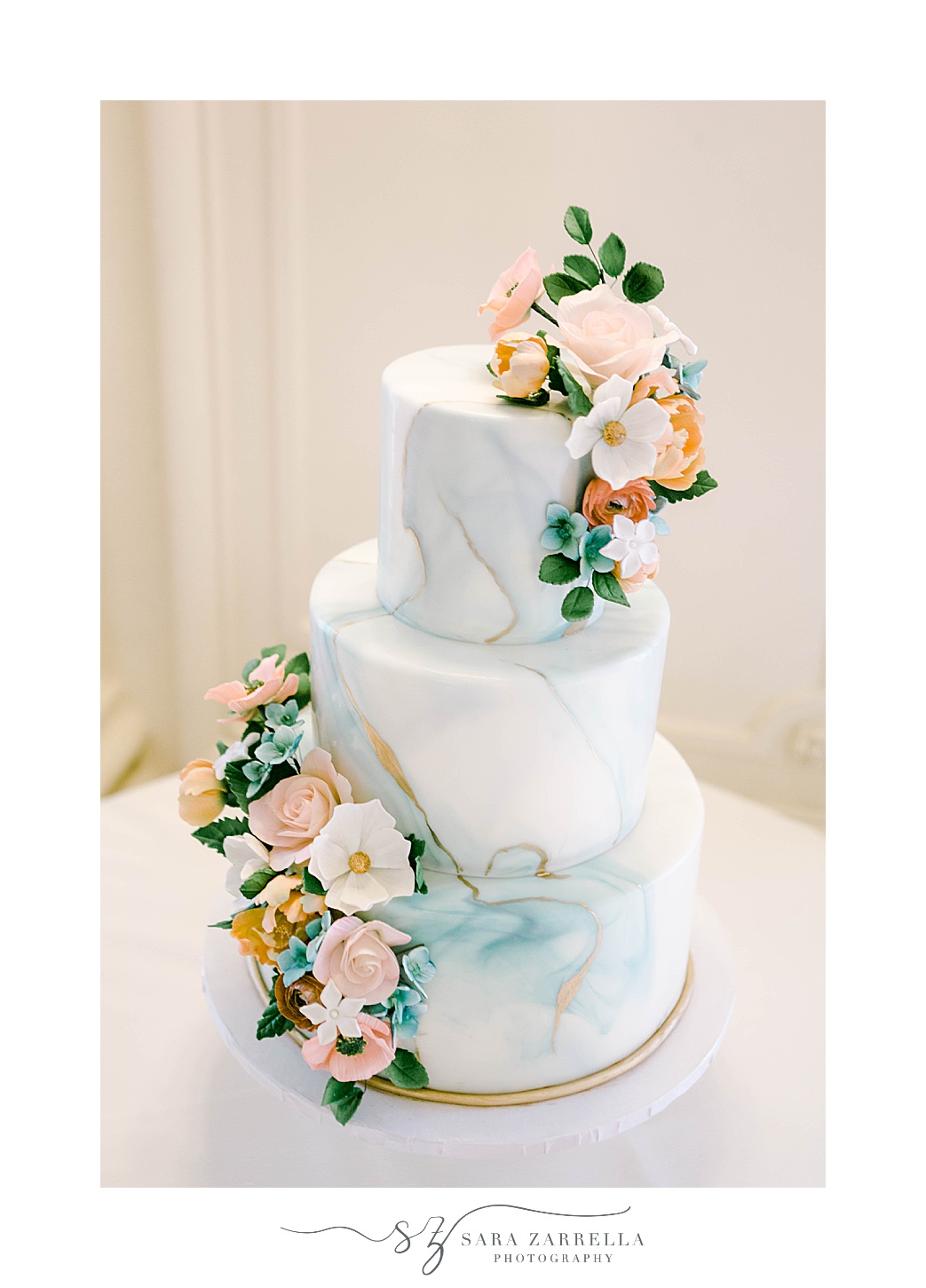 marbled wedding cake with pink and ivory floral accents