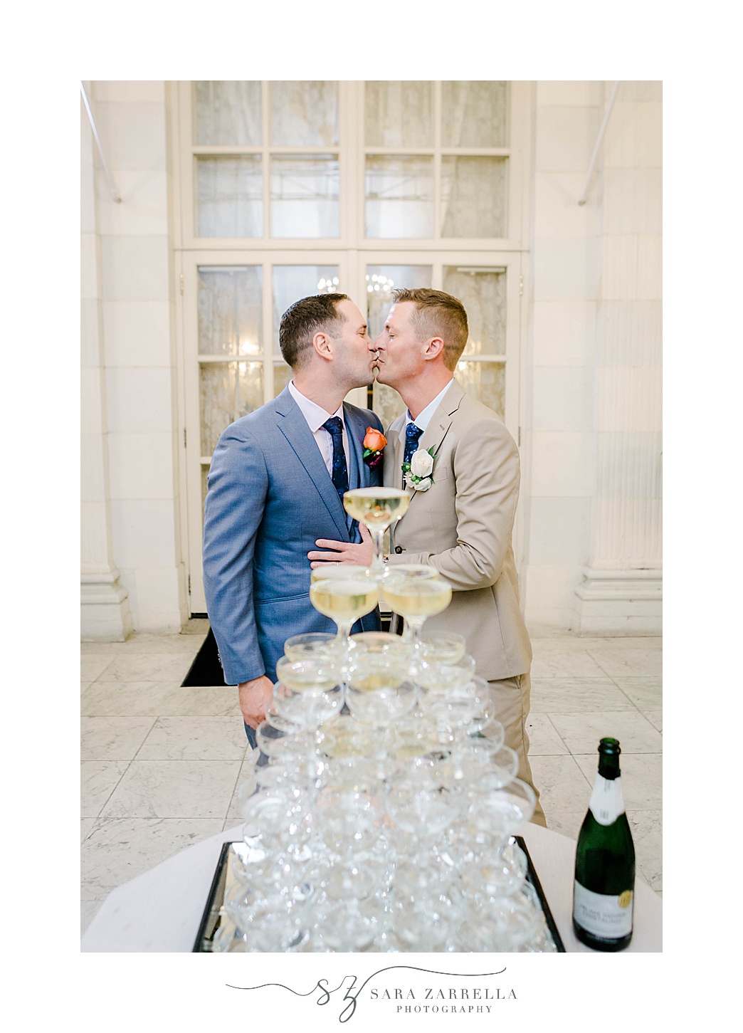 grooms kiss by champagne tower