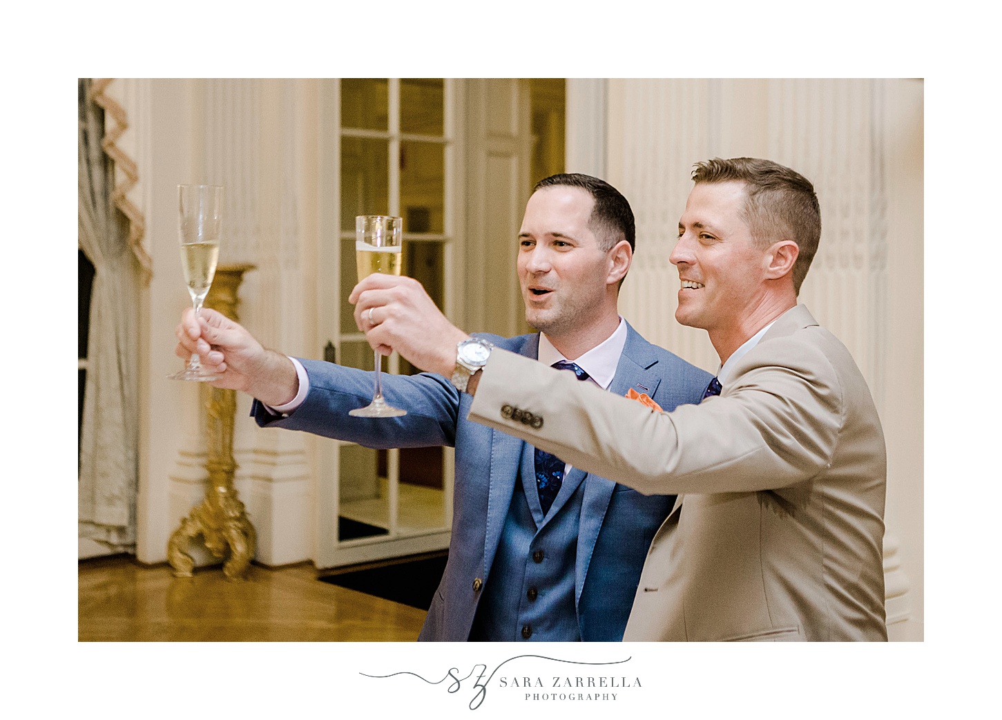 grooms lift champagne in toast for Newport RI wedding reception