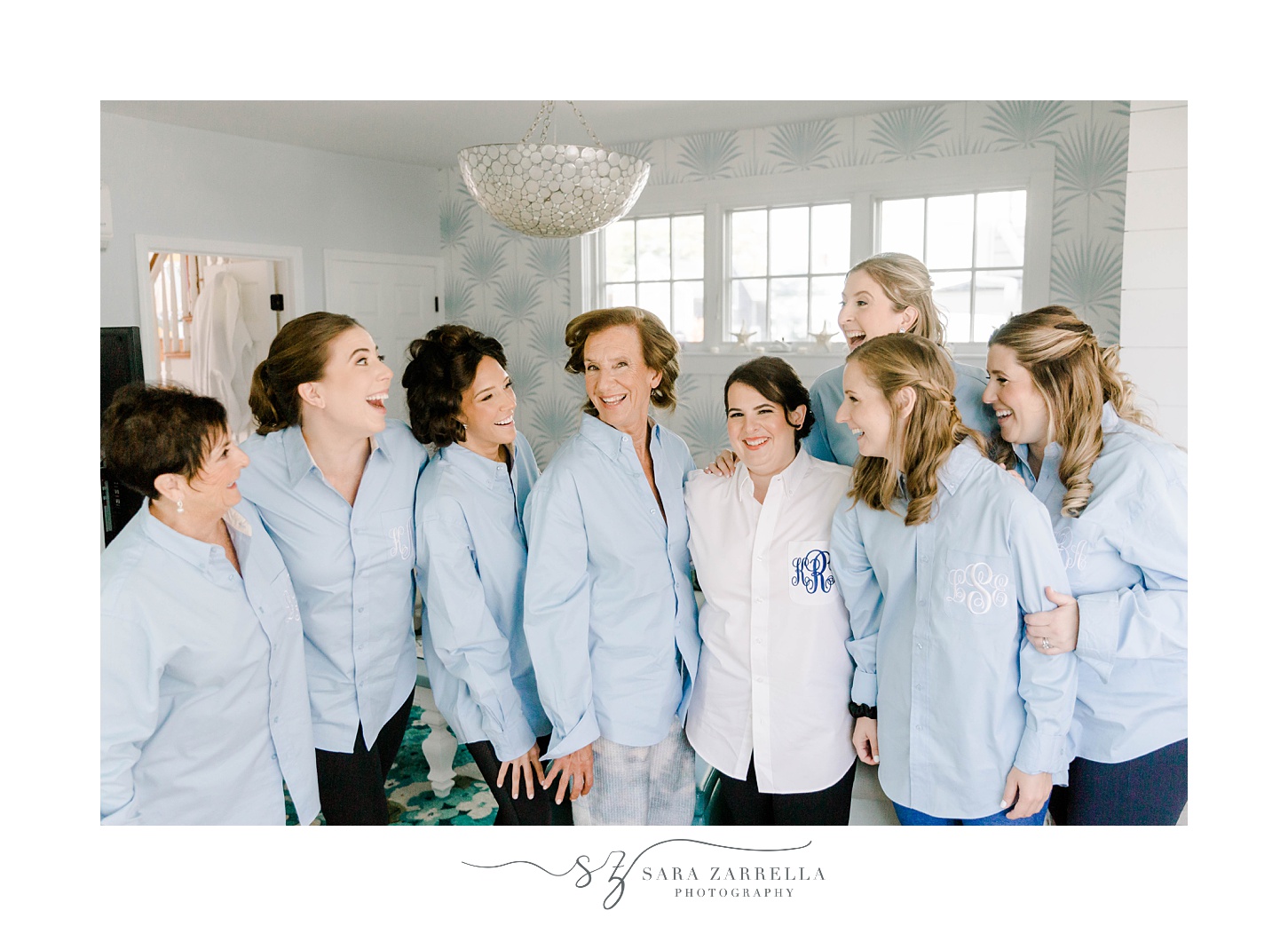 bride poses with bridesmaids and mother in custom monogramed shirts 