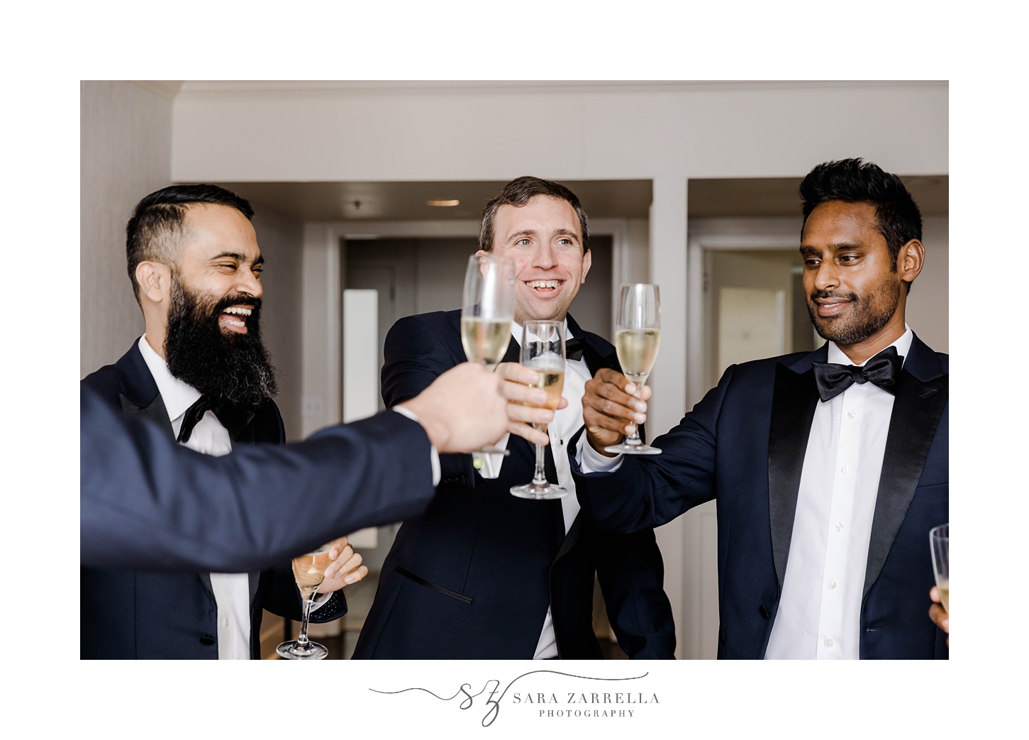 groom toasts champagne with groomsmen at Belle Mer