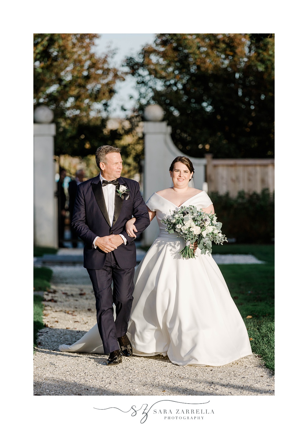 bride walks down aisle with father at Belle Mer