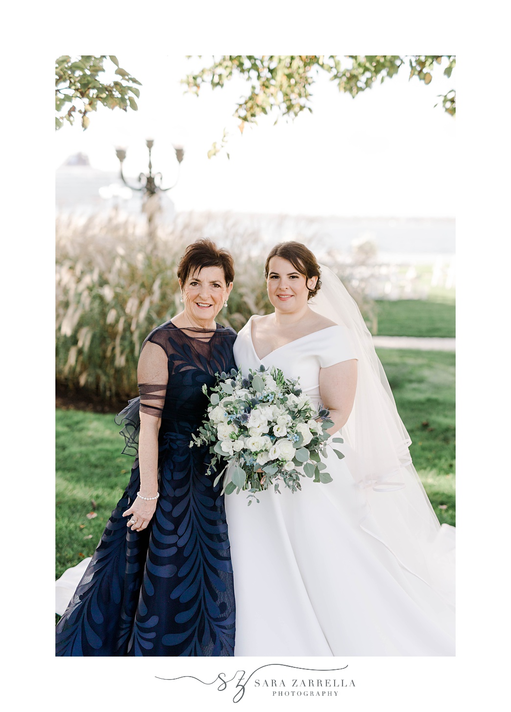 bride stands with mother in navy gown