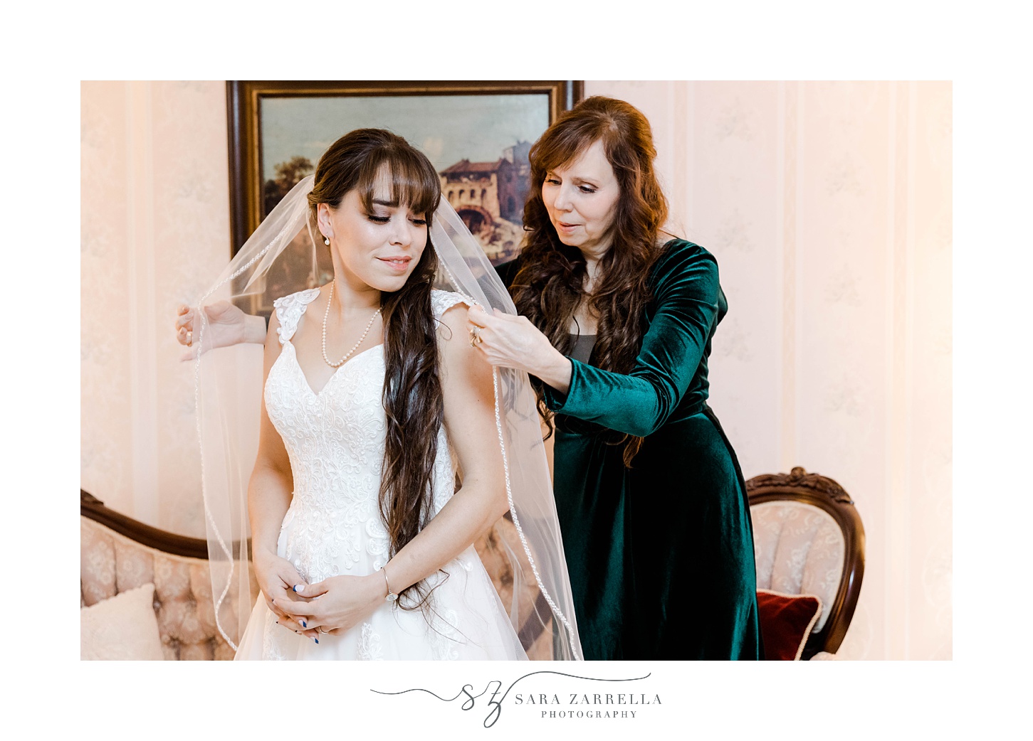 bridesmaid moves veil around bride's shoulders 