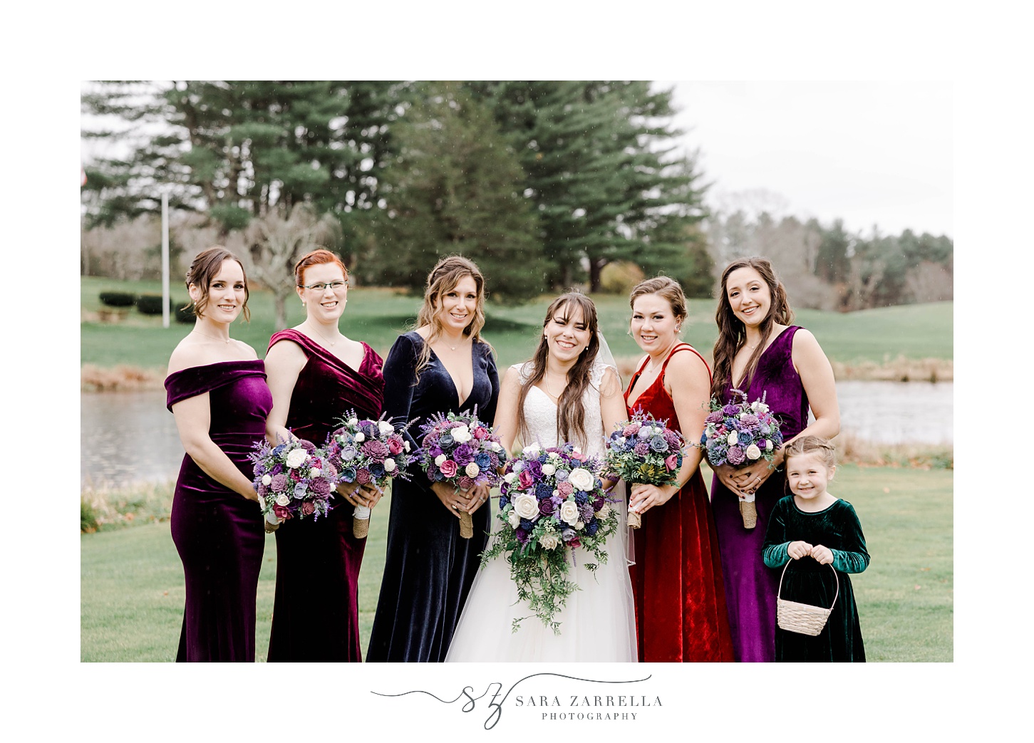 bride poses with bridesmaids in velvet gowns in metallic colors 
