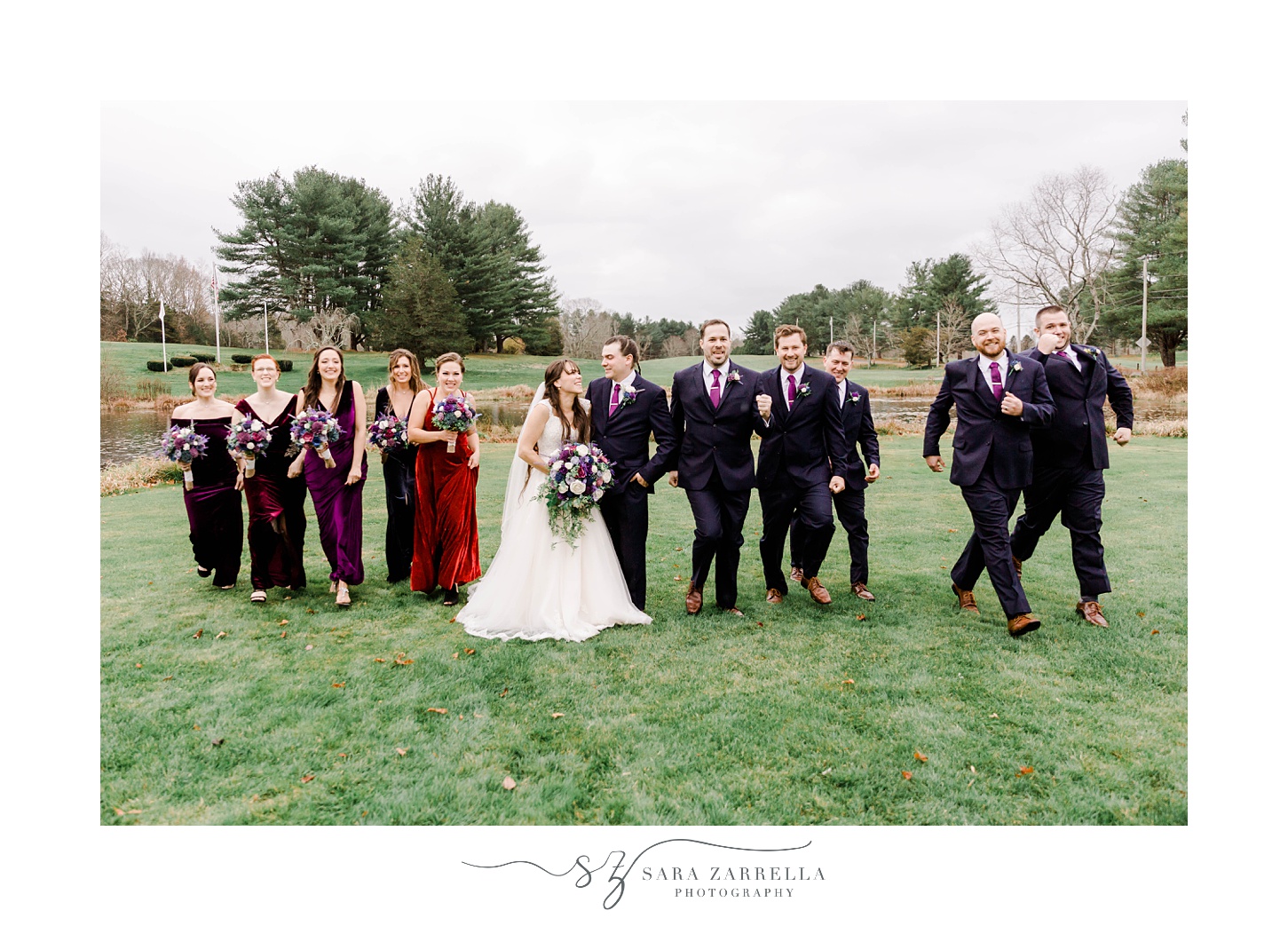 bride and groom stand with wedding party on lawn at Foster Country Club