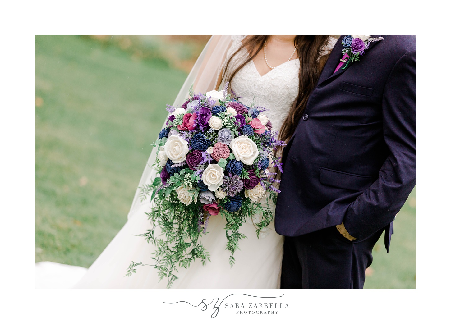 newlyweds hug while bride holds bouquet of purple and white flowers 