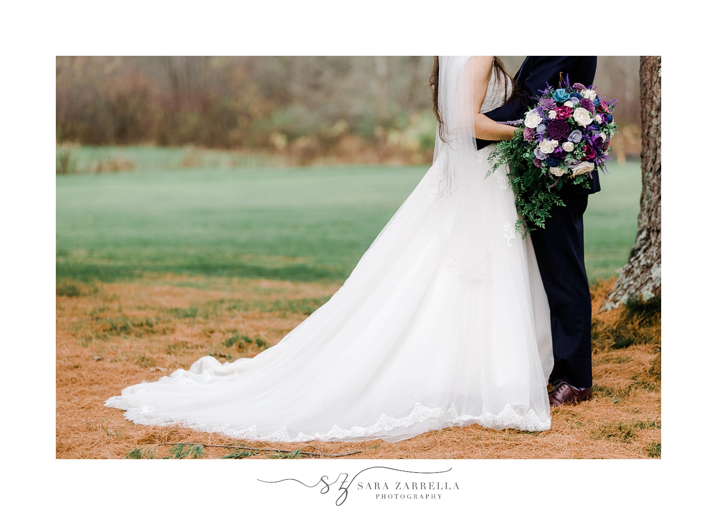 bride and groom walk through woods at Foster Country Club with bouquet of purple flowers 