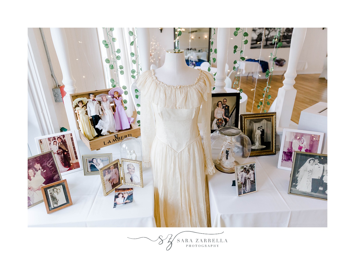 table with old wedding gown and portraits 