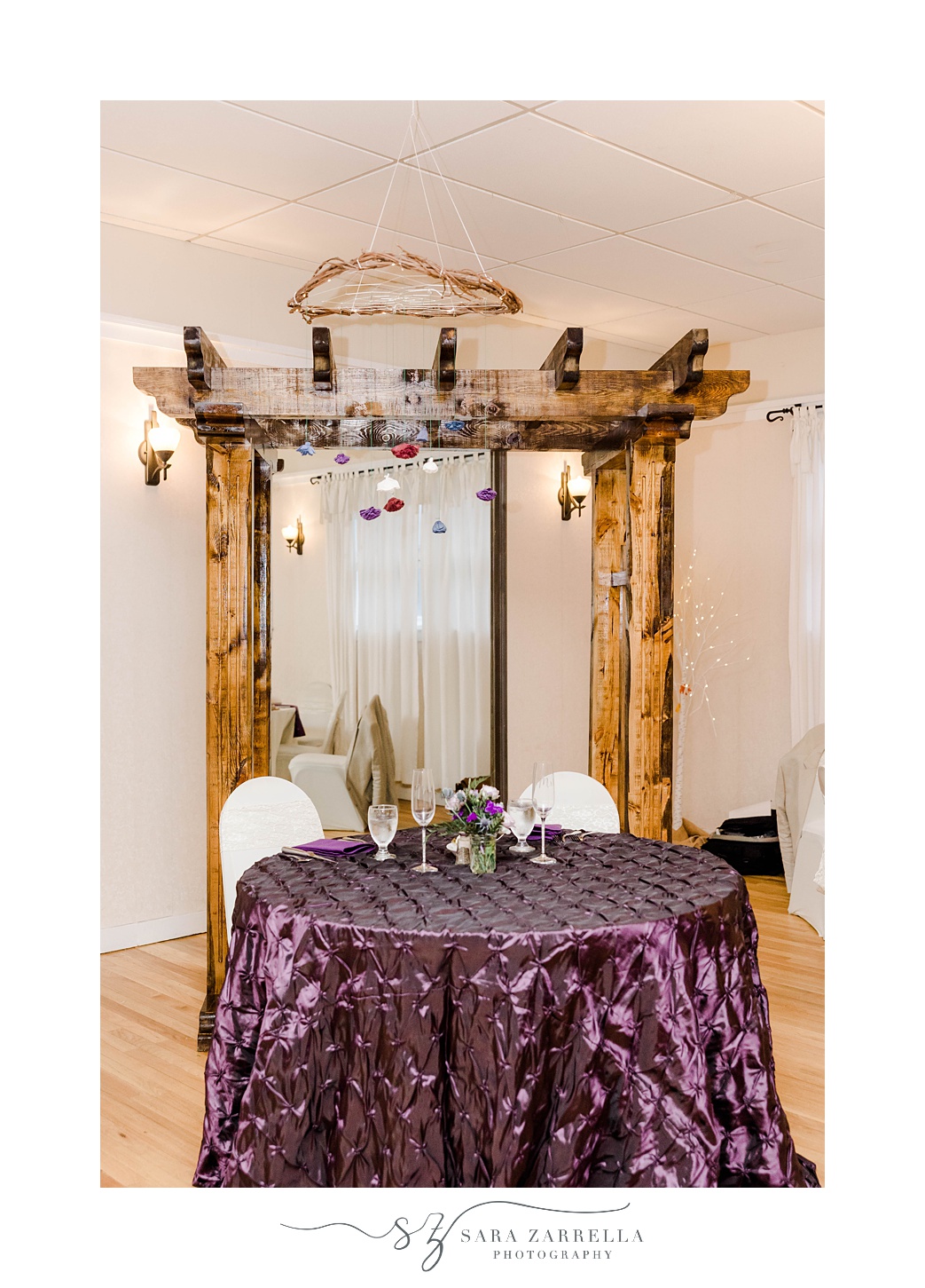 wooden arbor sits behind sweetheart table at Foster Country Club