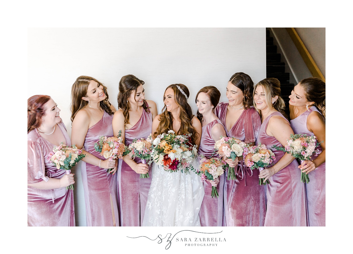 bride smiles with bridesmaids in pink velvet gowns at Newport Harbor Island Resort
