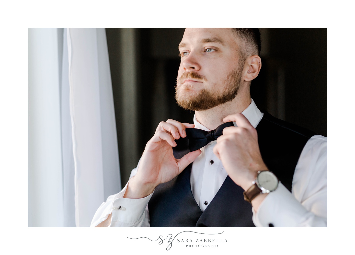 groom adjusts tie before RI wedding day