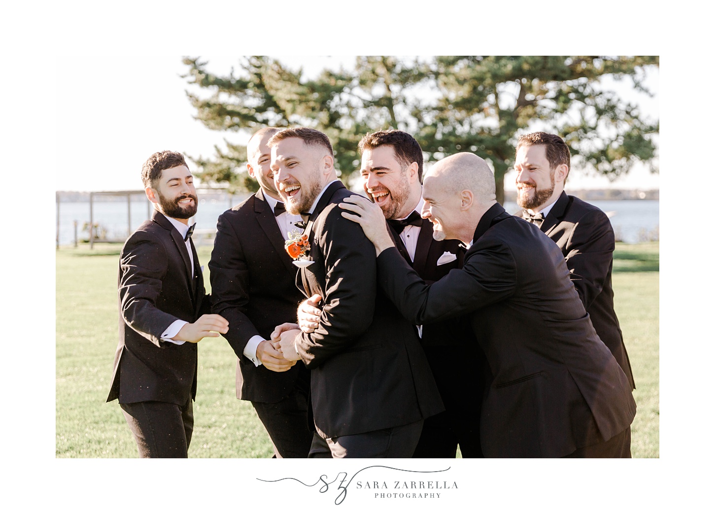 groomsmen laugh hugging groom at Newport Harbor Island Resort