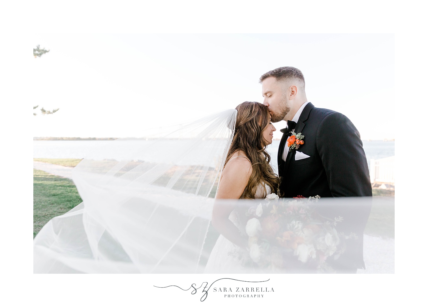 groom kisses bride's forehead with veil around them at Newport Harbor Island Resort