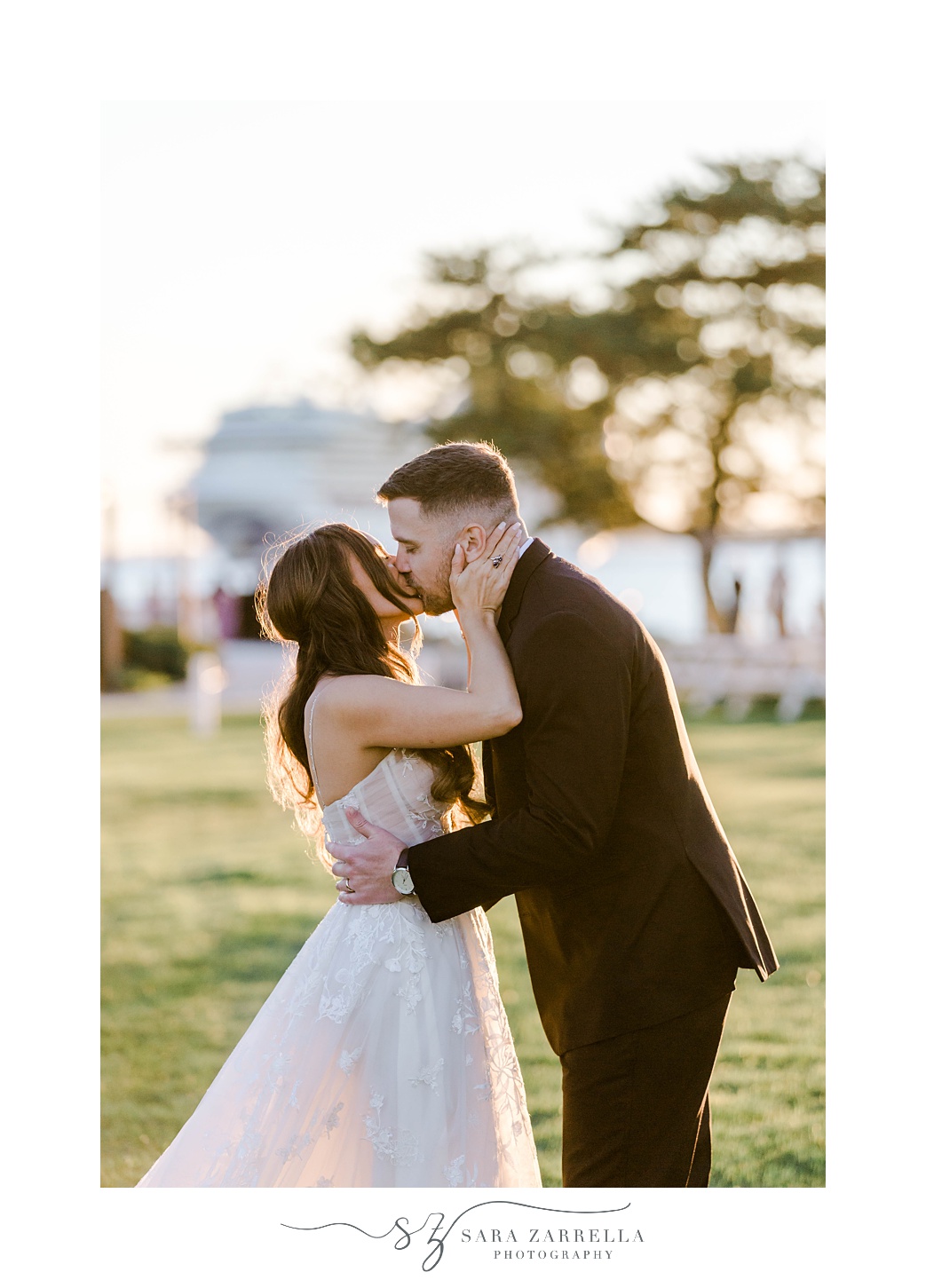 bride and groom kiss at sunset at Newport Harbor Island Resort