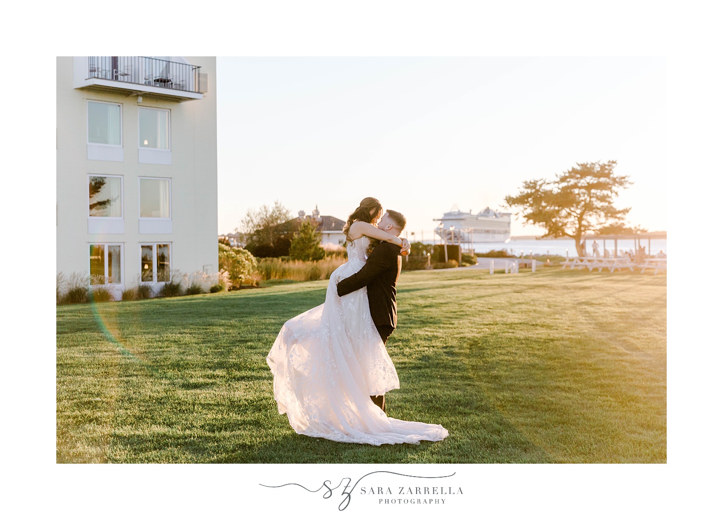groom lifts bride up and twirls her around at Newport Harbor Island Resort