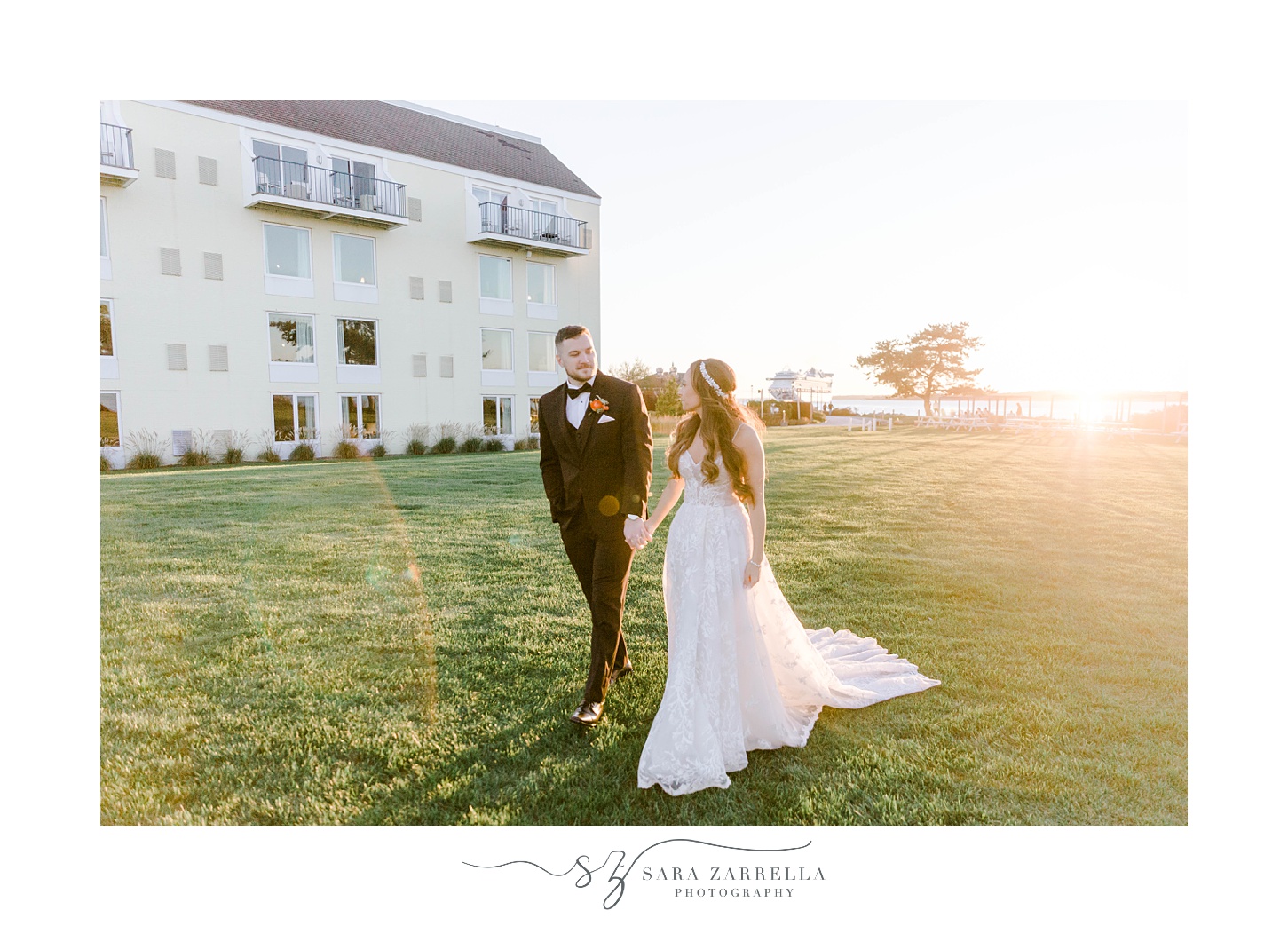 bride and groom hold hands walking on lawn at Newport Harbor Island Resort