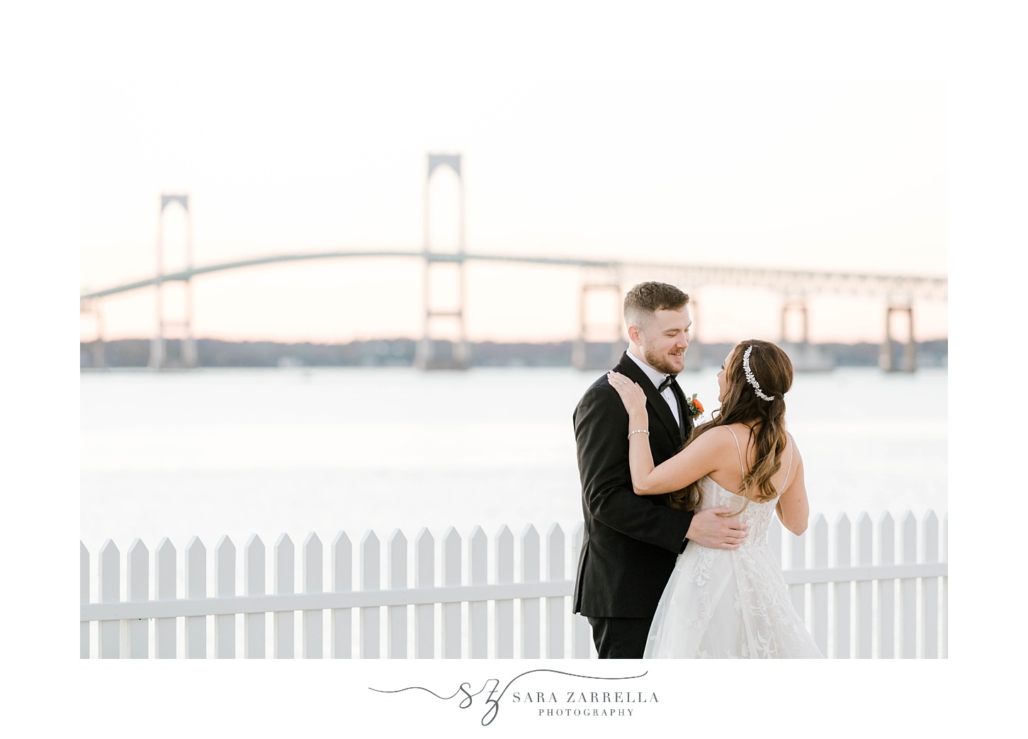 bride and groom dance with Newport Bridge behind them at Newport Harbor Island Resort
